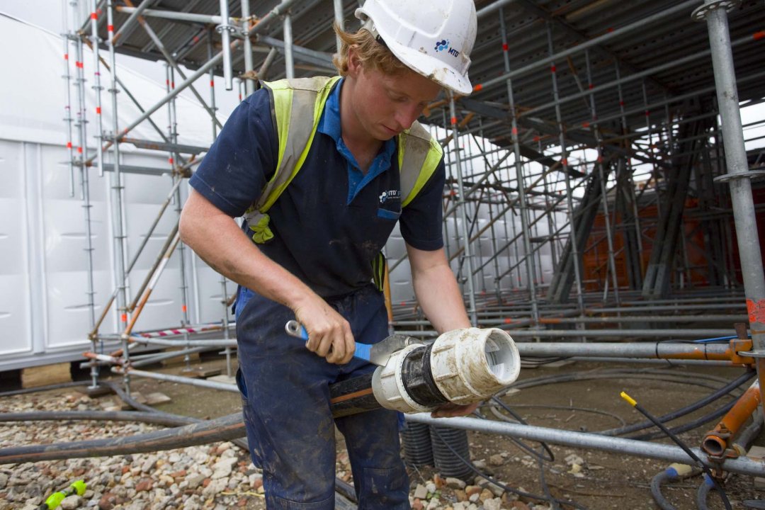 Worker installing MTD's standard temporary water system