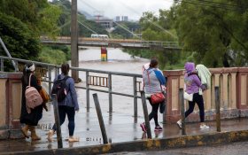 Four women walking in Tegucigalpa, with Eta storm approaching