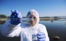 Ecologist sampling water from river