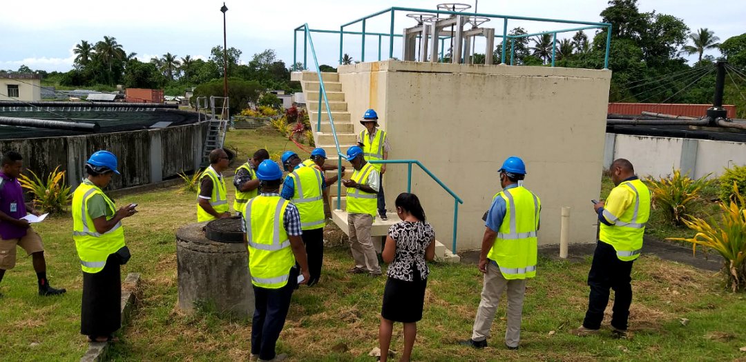 People in Fiji in the field collecting data for sgd6 water