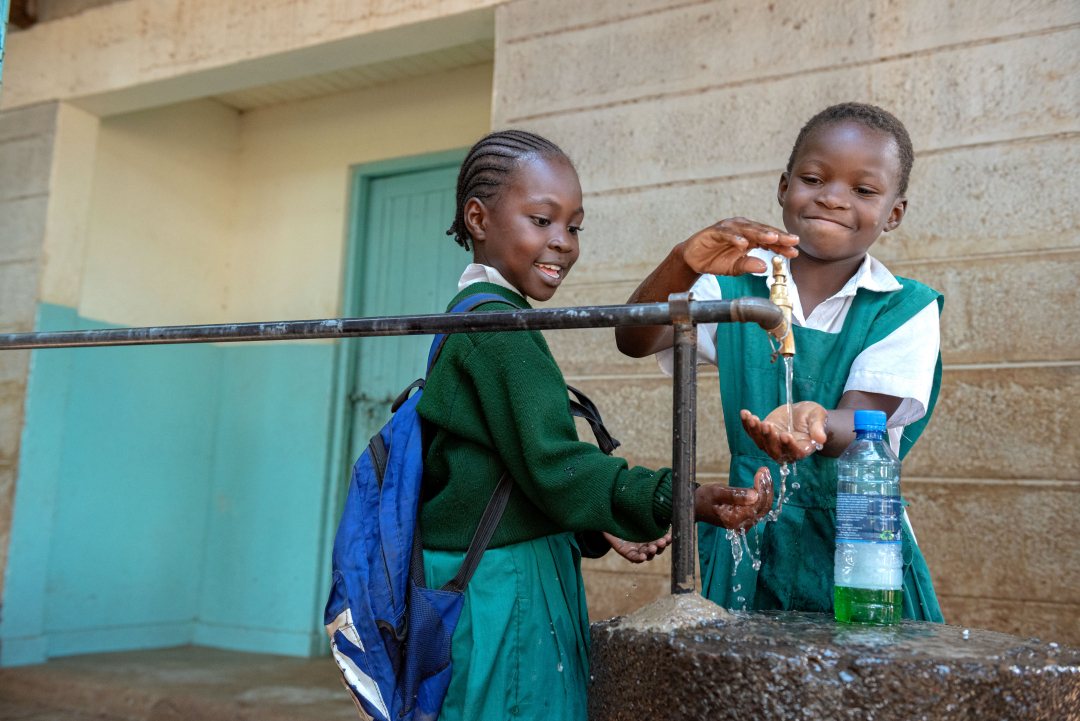 Children washing their hands.