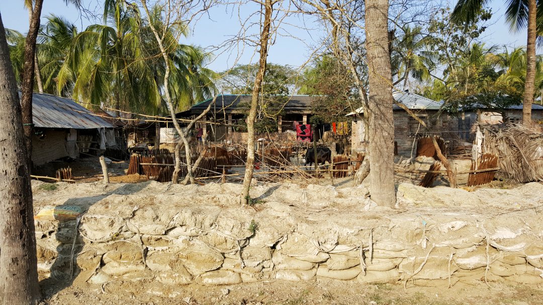 Coastal villagers near Khulna protect their houses with sandbags against high water, 2017