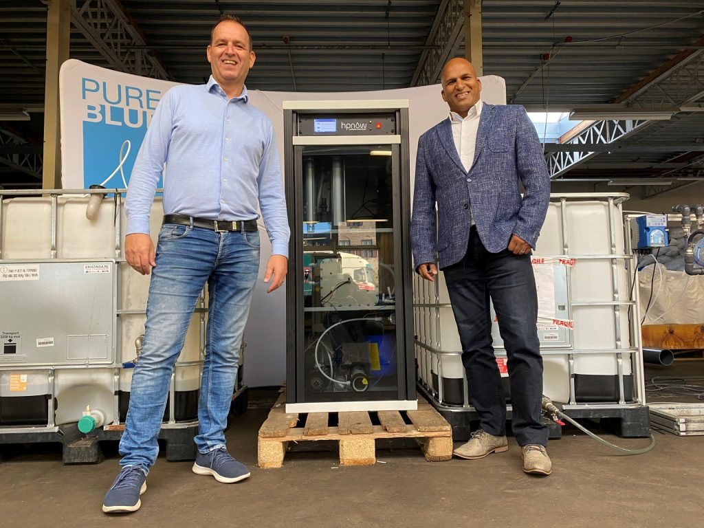 Angelo de Mul (left) of PureBlue and Tiret Dewnarain of HPNow in front of the Advanced oxidation unit to clean water