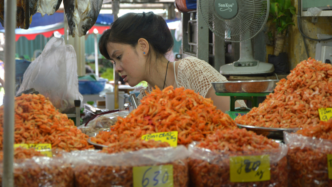 Dried shrimp vendor in a Vietnamese market. Photo: Unsplash