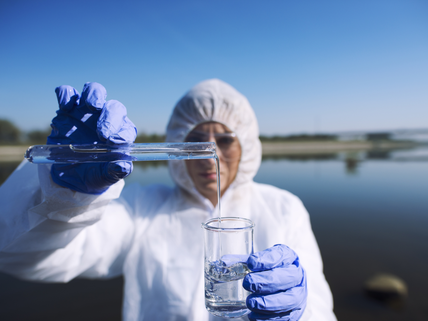 Ecologist sampling water from river