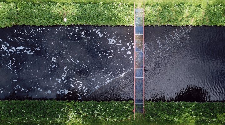 Aerial view of the bubble barrier placed diagonally in the effluent channel of wwtp Wevershoof