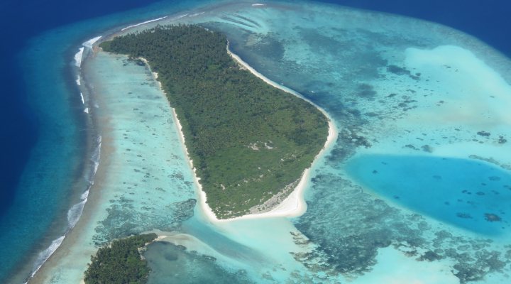 Aerial views of small island with coral reefs