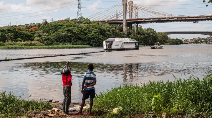 The Ocean Cleanup's Interceptor 004 collecting plastic waste on the Rio Ozama, Dominican Republic