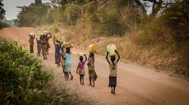Photo of African kids carrying jerrycans filled with water. Photo: Jeff Ackley /  Unsplash