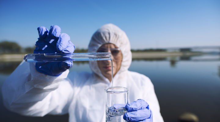 Ecologist sampling water from river