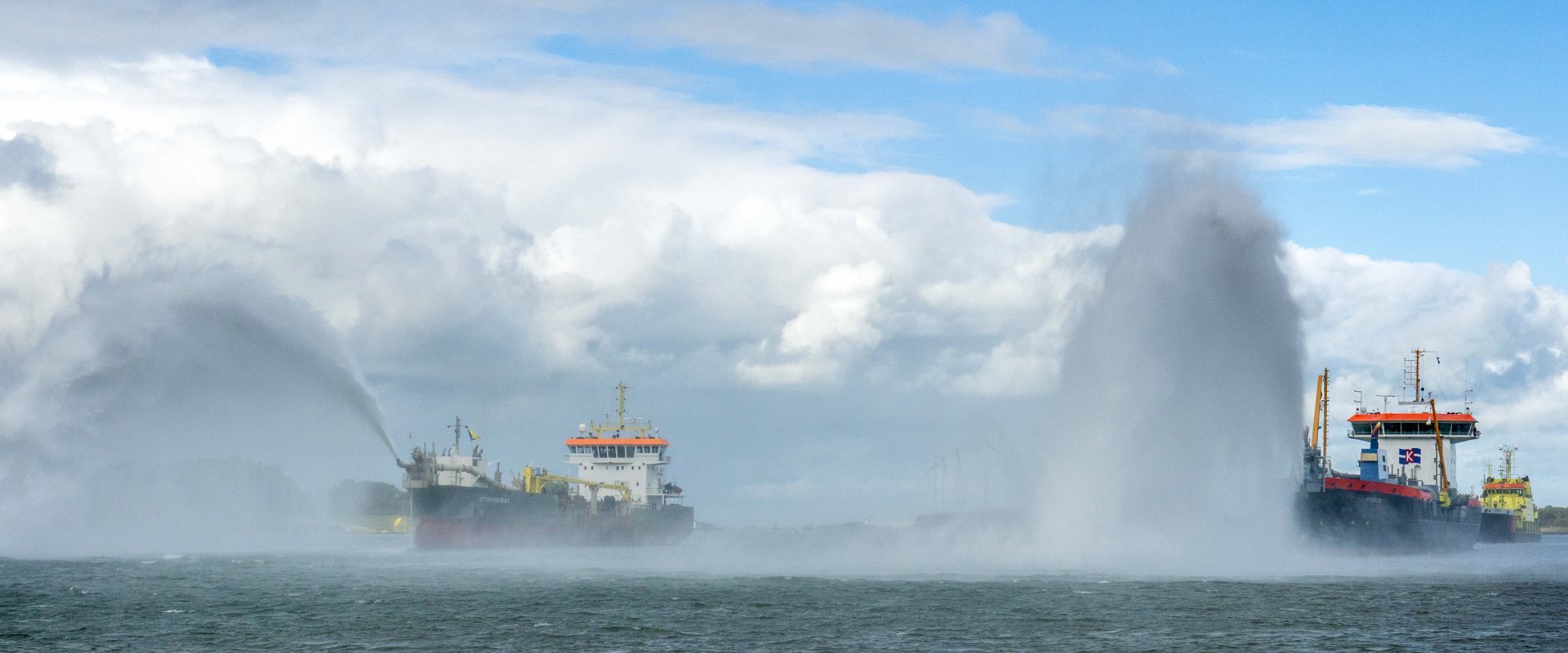 Nautical salut by two dredging vessels on the Nieuwe Waterweg, Rotterdam