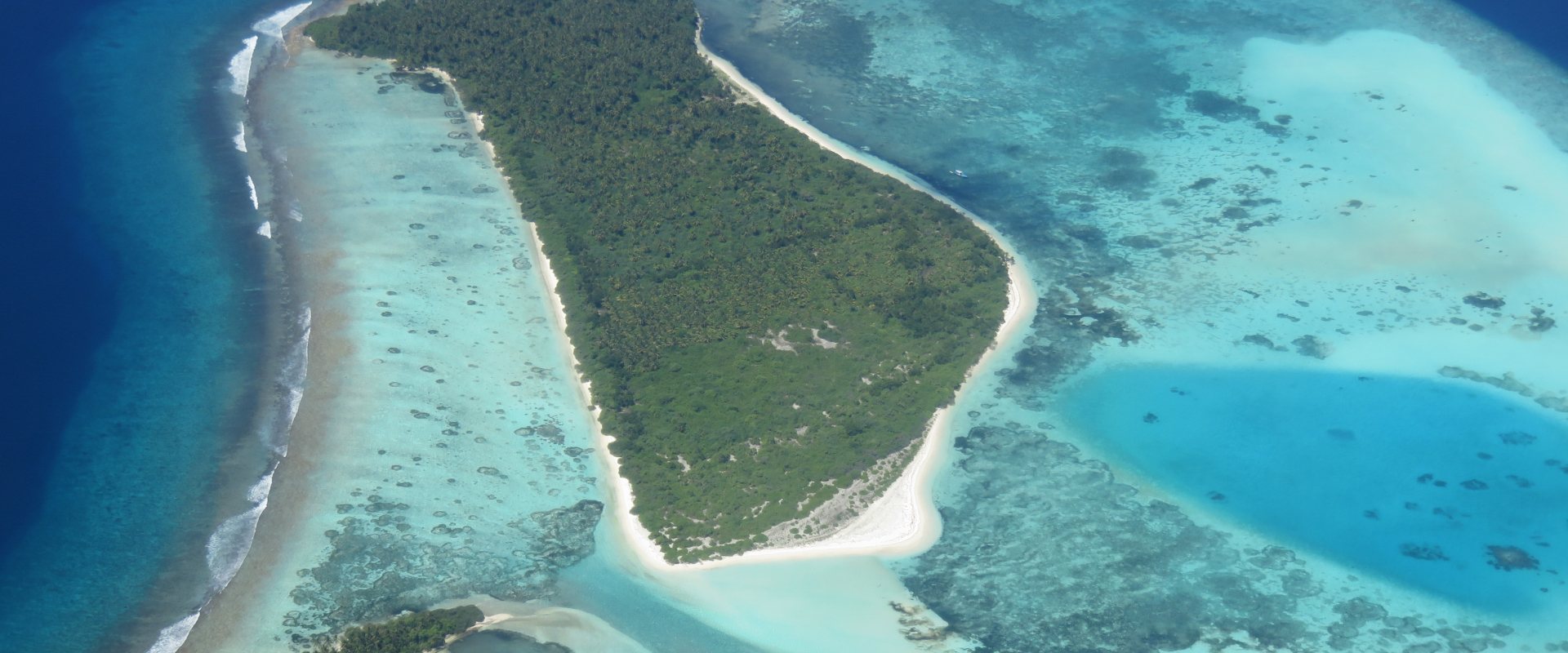 Aerial views of small island with coral reefs