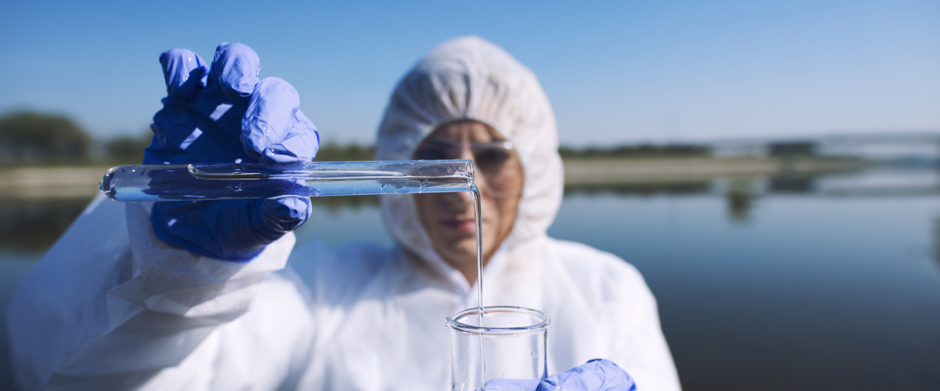 Ecologist sampling water from river